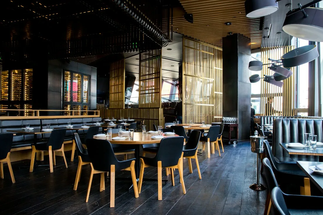 An atmospheric dining room with greenery and warm lighting